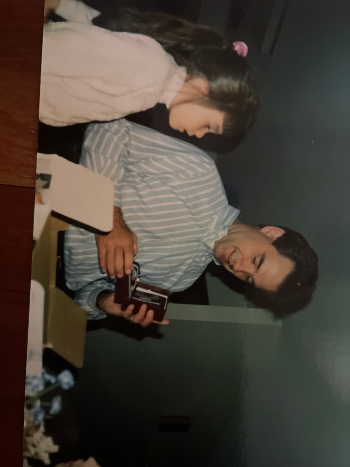 Kerry opening a gift with young Maura