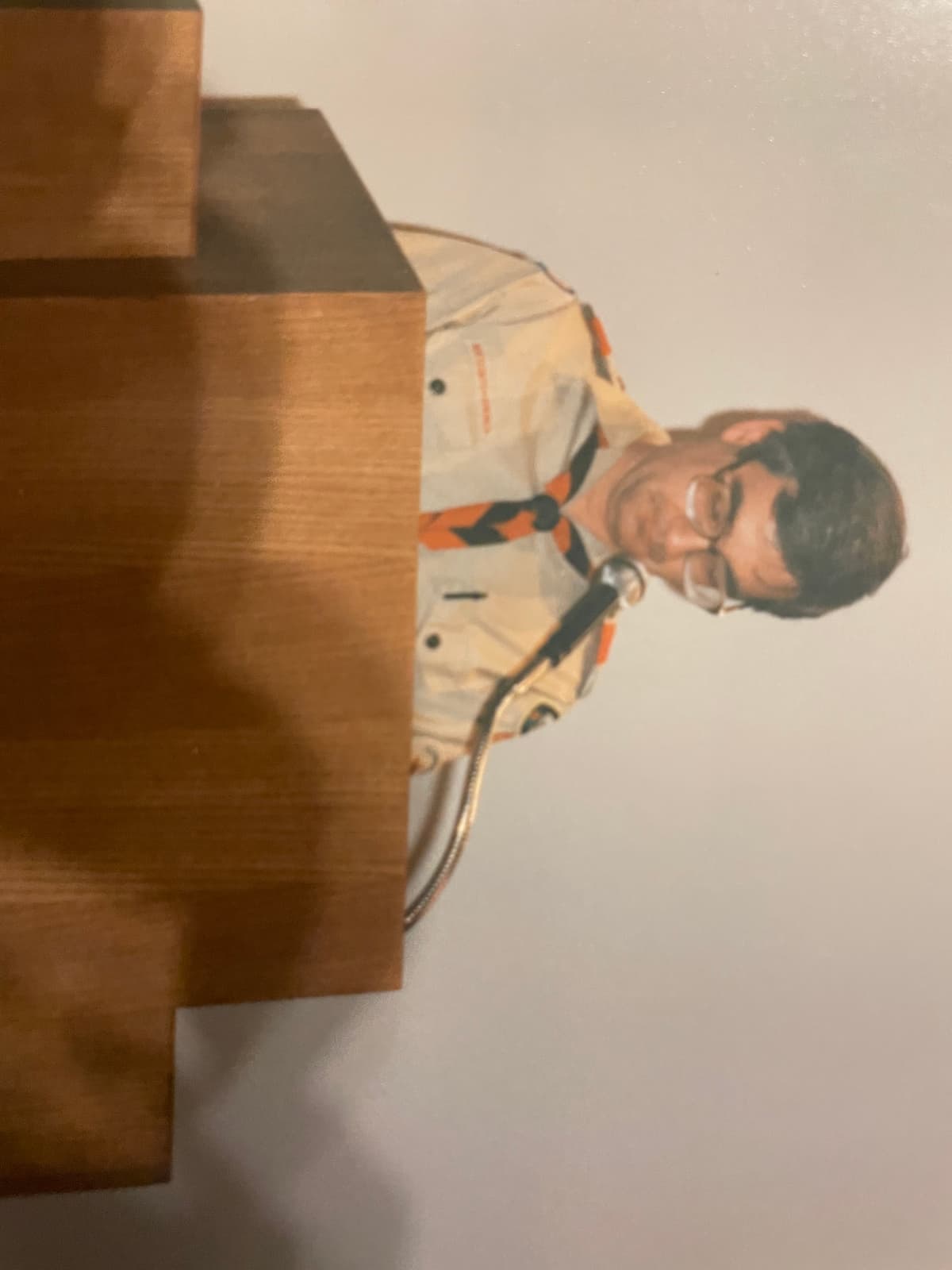 Kerry as Scoutmaster at a podium